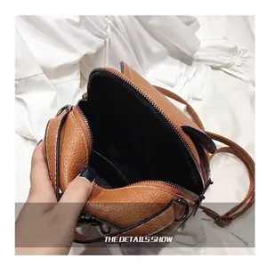 Brown faux leather mini backpack showing spacious interior compartment and inner lining