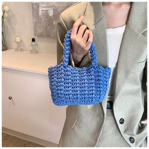 Dettaglio ravvicinato di una borsa blu fatta a mano all'uncinetto con trama in cotone