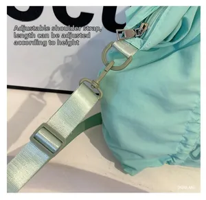 Detail of adjustable mint green shoulder strap with silver metal swivel hook and buckle