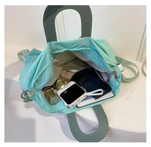 Interior view of mint green nylon bag showing spacious storage for daily items