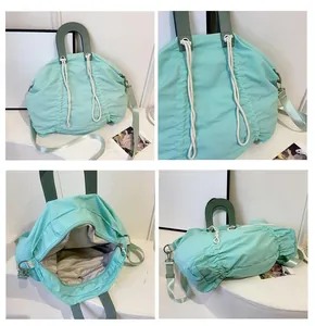 Detailed four-way view of mint green drawstring canvas bag with leather handle