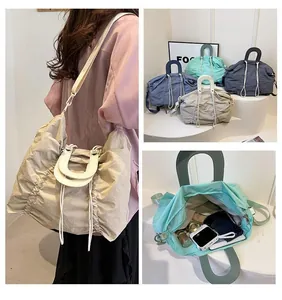 Detail showing various colors and large capacity of pleated nylon tote bag with straps