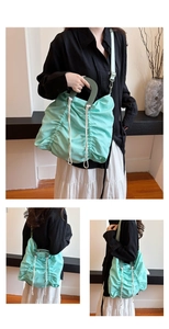 Close-up of light green pleated canvas tote with white drawstrings and wide nylon strap
