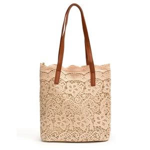 Elegant beige crochet lace tote bag with brown leather handles on white background