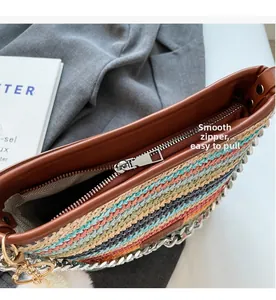 Detailed macro of smooth metal zipper closure on a colorful woven straw bucket bag