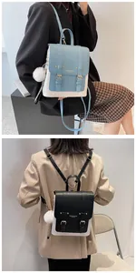 Detail view of contrast PU leather backpack featuring dual buckles and a plush ball charm