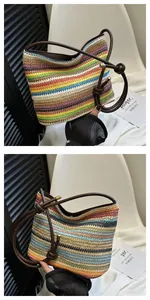 Detail of bohemian rainbow straw shoulder bag with multi-color stripes and leather knotted strap