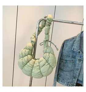 Vue détaillée du sac croissant vert clair avec texture plissée et forme de croissant
