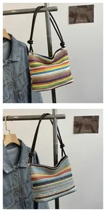 Detail view of rainbow woven bucket bag showing colorful stripes and a dark brown handle
