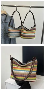 Close-up of the rainbow striped woven tote bag featuring a brown leather knotted strap detail