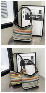 Detail of colorful striped woven bucket bag with brown knotted handle and gold metal tips