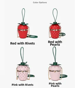 Detail view of strawberry shaped chain bags with pearl and rivet decoration options