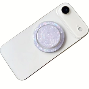 Collapsible round phone grip with lavender shell texture on white smartphone