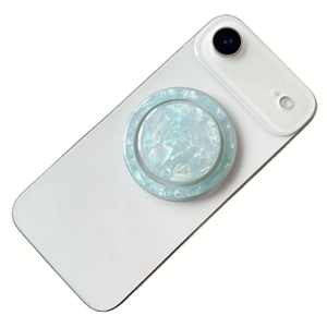 Close-up of a circular shell pattern phone socket with green pearlescent texture detail