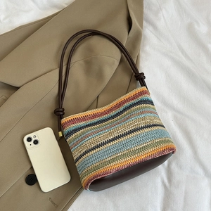 Rainbow striped straw bucket bag with brown leather knotted shoulder strap and beach vibe
