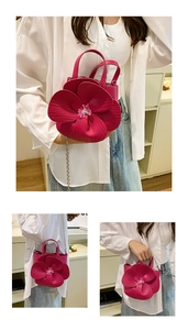 Detail of 3D rose petal handbag in deep pink with a gold chain strap and PU leather texture