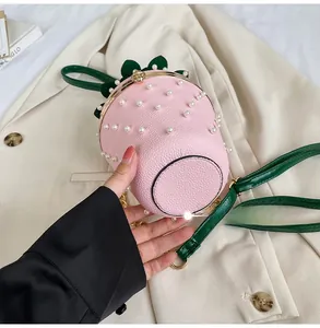 Detail showing the bottom of the strawberry bucket bag with pink textured leather and pearls