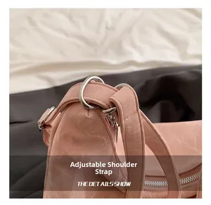 Detail of adjustable strap with silver metal ring on textured pink faux leather bag