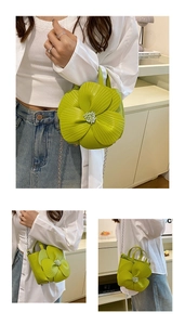 Detail of lime green bucket bag with 3D camellia flower and silver chain strap