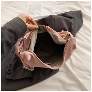 Detailed view of pink bow tote interior with herringbone lining and zipper pocket