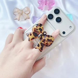 Leopard print bow acrylic phone grip holder with expandable stand on mobile device