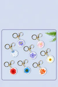 Collection of handmade resin keychains with real dried flowers and golden metal rings
