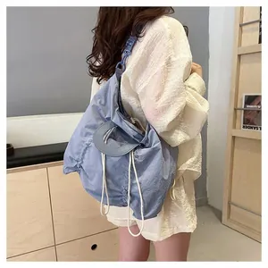 Light blue pleated nylon tote bag with drawstring closure and round handles