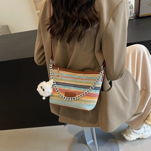 Striped woven straw bucket bag with metal chain and plush charm for summer fashion
