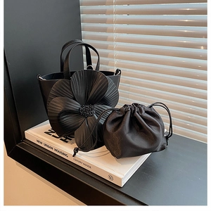 Detailed close-up of a 3D floral petal handbag with beaded center and drawstring pouch