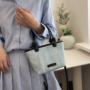 Fashionable denim handbag with rivet studs and black leather straps for women