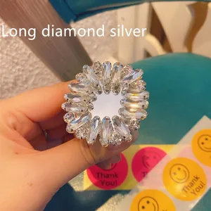 Macro shot of silver crystal flower phone socket with long diamond-cut rhinestones