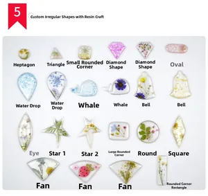 Macro display of diverse geometric resin pendants with dried flowers and gold leaf details