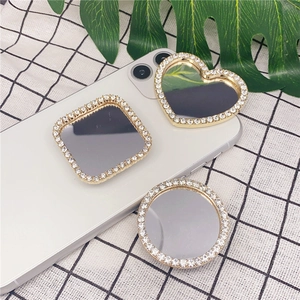 Close-up of heart, square and round rhinestones makeup mirror phone socket grips
