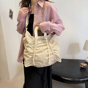 Minimalist beige pleated canvas tote bag with cream leather handles for women