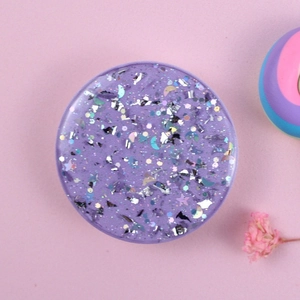 Purple glitter heart phone socket with stars and moon sequins on pink backdrop