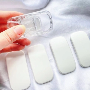 Transparent pull-push mobile phone stand and holder accessory on a white fabric background