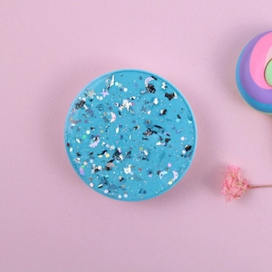 Macro shot of light blue glitter phone grip with silver stars and moon sequins