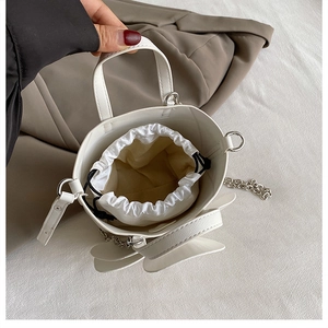 Top view of white 3D petal bucket bag with drawstring inner and metal chain strap