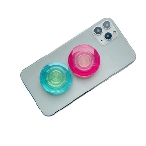 Transparent pink and teal gradient pop sockets for phones with concentric ring texture