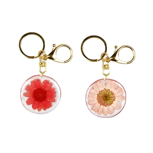 Handmade clear resin keychains with real dried flowers and gold metal hardware