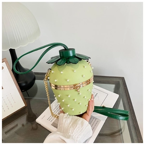 Detail of strawberry-shaped bucket bag with pearl beads and gold chain strap