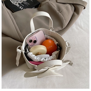 Top view of white bucket bag showing inner space for phone, cushion, and cosmetics