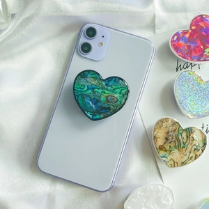 Detailed view of heart-shaped phone socket with iridescent shell texture and glossy resin finish