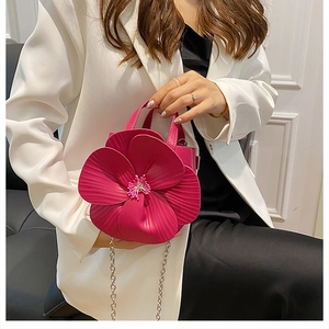 Detail of rose red 3D camellia flower handbag with metallic chain strap and PU texture