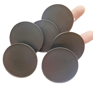 Set of six black circular phone socket grips with matte finish on white background