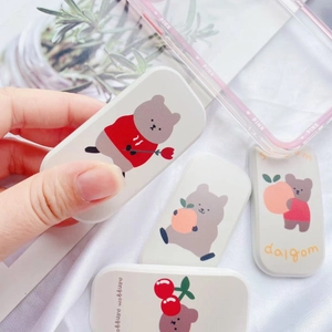 Detail view of cute cartoon cherry bear foldable phone stand with matte printing