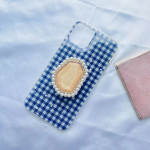 Detail of blue checkered phone case with luxury pearl and rhinestone socket mount