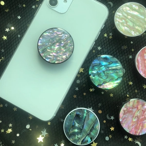 Detail of natural abalone shell pattern foldable cell phone grips on mesh background