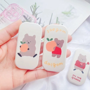 Close-up of cute cartoon Quokka storage box held in hand with soft pastel background