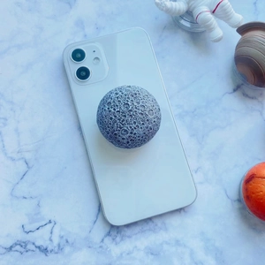 Detail of 3D moon texture phone socket with realistic craters on a white smartphone